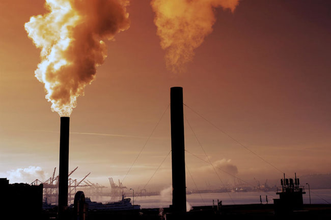 Pipes pumping smoke pollution into the air